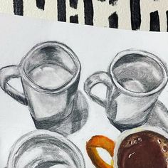 a drawing of two cups of coffee and some pretzels