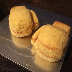 three biscuits sitting on top of a plastic tray