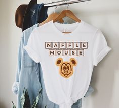 a t - shirt with the words waffle mouse on it hanging from a clothes rack