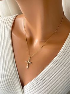 This is a 18kt gold-filled ornate crucifix cross pendant necklace.  Shown on a shiny 18kt gold filled box chain that measures 18" length.  his beautiful crucifix measures 35x20mm with bale. Please not that 18k gold filled is deeper in gold color, almost a pinkish gold.  Ships in a cute gift box ready to present. Gold filled jewelry is an actual layer of gold pressure bonded to another metal. Gold filled is not to be confused with gold plating as filled has 100% more gold than gold plating. Gold filled is much more valuable. Anyone that can wear gold, can wear gold filled jewelry without worries of an allergic reaction.  Gold-filled items are generally considered lifetime products and the gold layer will not wear off, as it will with gold-plated products. Yellow Gold Cubic Zirconia Cross Necklace, Dainty Cubic Zirconia Cross Jewelry, Dainty Gold Crucifix Jewelry, Dainty Cross-shaped Cubic Zirconia Jewelry, Dainty Cross Jewelry In Cubic Zirconia, Gold Cubic Zirconia Cross Pendant Necklace, Elegant Gold Plated Cross Pendant Necklace, Gold Cubic Zirconia Crucifix Necklace, Cubic Zirconia Crucifix Necklace For Gift