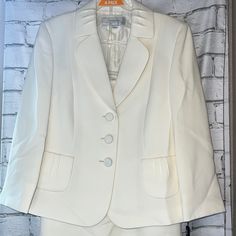 Ladies Suit Set By Tahari! Ivory. Blazer With Button Up Front. Knee Length Pencil Skirt. Size 6. Nwt! Blazer: -Pit To Pit: 19" -Waist: 17" -Length: 26" Skirt: -Flat Waist: 15" -Flat Hips: 19.5" -Length: 24" 100% Polyester. Dry Clean Only. 6.24 Chic White Skirt Suit For Semi-formal Occasions, Tailored White Skirt Suit For Office, Chic Tailored White Skirt Suit, Chic White Tailored Skirt Suit, White Fitted Skirt Suit For Office, Tailored Classic White Skirt Suit, Classic White Skirt Suit For Spring, White Classic Skirt Suit For Spring, Elegant Off-white Workwear Blazer