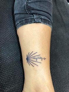 a woman's foot with a tattoo on it that says mayday and an arrow