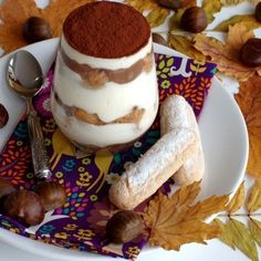 a dessert is on a plate with autumn leaves around it