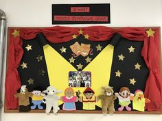 the stage is decorated with puppets and costumes