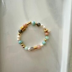 This fresh water pearl and mixed gemstone beaded bracelet features a  mix of 18K gold-filled beads with a fun mix of pastel shades of light greens and peach natural gemstone beads. It is the perfect bracelet to wear alone or add to your bracelet stack. It will make as a great gift to others and even yourself!  Materials: This bracelet features a mixed array of all natural healing gemstones with dainty freshy water pearls and is finished with 18K gold filled hardware.  Gemstones: Aquamarine, Larimar, Sunstone *Please note due to the unique coloring of each gemstone, the colors and variation of your piece may differe slightly from what is shown in the listing photos. Sizing: Standard size 7" - This size fits most! If another size is needed, please note before check out. *Please note exchange Gold Beaded Bracelets With Pearl And Gemstone Beads, Gold Pearl Bracelets With Gemstone Beads, Pearl Beaded Bracelets With Natural Stones, Natural Stone Pearl Beaded Bracelets, Candy Bracelet, Healing Gemstones, Shades Of Light, Gemstone Beaded Bracelets, Fresh Water Pearl