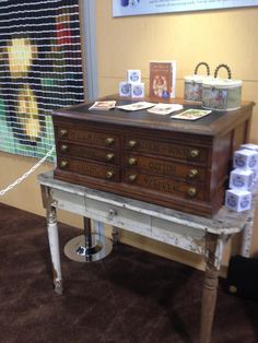 an old dresser is on display in a room with pictures and other items around it