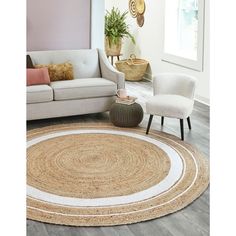 a living room with a white couch and beige rug on the floor next to a chair