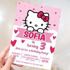 a hello kitty birthday party with pink and red hearts on the front, white lettering that says sofia is turning 3