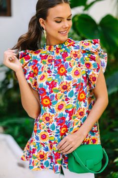 This bold blouse is stunning! It's going to look so fabulous this spring or summer! This blouse has a white background which makes those colorful flowers really pop! This blouse is going to look amazing with white jeans! This blouse features a high neckline, ruffled cap sleeves, a ruffled hemline, and a colorful floral print. Material has no amount of stretch.Sydney is wearing the small. White Floral Blouse, Floral Cocktail Dress, Black Tie Dress, Long Sleeve Outerwear, Mint Julep Boutique, Two Piece Swimwear, Cute Boutiques, Boutique Tops, Mint Julep