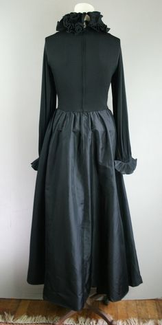 "This is a beautiful and timeless gown by designer Victor Joris (His bio is very interesting and accomplished). This garment features a dramatic ruffled neckline embellished with a white magnolia (a nod to his Louisiana roots) and ruffled cuffs. It is fully lined and impeccably constructed. Estimated size M/L 38\" bust 28\" waist full hip 40\" waist to hem (with 3\" hem) Purveyor's Note: We have searched far and wide, wrestled bears, braved the cold, traversed mountain ranges, fought pirates, sw Classic Vintage Dress With Fitted Bodice For Formal Occasions, Elegant Vintage Dress For Fall Costume, Elegant Vintage Fall Costume Dress, Historical Ball Gown Dresses For Formal Occasions, Elegant Fall Costume Vintage Dress, Historical Formal Ball Gown Dresses, Elegant Fall Vintage Costume Dress, Elegant Vintage Ruffled Dress For Costume, Formal Vintage A-line Dress With Ruffles