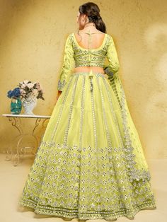 Introducing our captivating lime yellow foil work net engagement wear lehenga choli, a stunning ensemble that will make you the center of attention at any special occasion. This exquisite outfit features a lime yellow color net material lehenga with intricate foil work, complemented by a similar color net material choli also adorned with foil work. Complete your look with the included matching net dupatta, which features both foil work and beautiful lace work.
The lime yellow lehenga is semi-sti Yellow Organza Choli With Dori Work, Pista Green Floor-length Organza Lehenga, Yellow Organza Set With Intricate Embroidery, Yellow Organza Sets With Intricate Embroidery, Yellow Organza Sets With Dori Work, Yellow Organza Lehenga With Intricate Embroidery, Yellow Organza Choli With Intricate Embroidery, Pista Green Semi-stitched Organza Lehenga, Green Net Lehenga For Eid