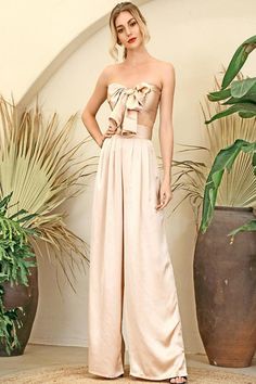 Silky Strapless Tie Front High Waisted Wide Leg Nude Two Piece Pants Set Make a bold statement! Perfect for a night out on the town in this two-piece pant set offers super chick style, Featuring wide-leg pants and a bandeau crop top. A strapless tie front bandeau crop top bow knots in the center, that lets you show plenty of skin and a pair of matching high waist palazzo pants with wide legs that create a gorgeous silhouette. Pair it with strappy heels for a great head-to-toe look! High waist pa Elegant Summer Two-piece Pants Set, Elegant Two-piece Summer Pants Set, Glamorous Strapless Jumpsuit For Spring Evening, Glamorous Spring Evening Strapless Jumpsuit, Chic Summer Evening Sets, Chic Evening Sets For Summer, Summer Party Jumpsuit With High-waisted Pants, Spring Strapless Jumpsuits And Rompers For Going Out, Strapless Jumpsuits And Rompers For Spring Going Out