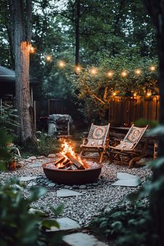 Cozy backyard with a fire pit, string lights, and two wooden chairs. Large Fire Pit Ideas Outdoor Spaces, Bon Fire Pit Ideas Backyards, Outdoor Fire Pit Patio Ideas, Backyard Corner Fire Pit Ideas, Fire Pit In Woods, Natural Fire Pit Ideas, Simple Outdoor Patio Ideas, Outdoor Fire Cooking, Rustic Fire Pit Ideas Backyard