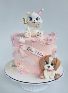 a pink cake with a dog on top