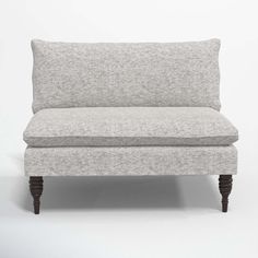 a gray couch sitting on top of a white floor