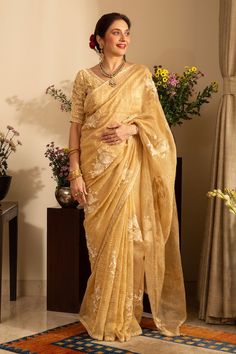 Soft gold pure silk tissue saree with parsi, floral and thread embroidery. Comes with an unstitched blouse piece and an unstitched petticoat. - Aza Fashions Designer Gold Embroidered Pre-draped Saree, Designer Embroidered Gold Pre-draped Saree, Gold Organza Pre-draped Saree With Resham Embroidery, Gold Pre-draped Saree For Reception, Gold Tussar Silk Pre-draped Saree For Reception, Gold Pre-draped Saree With Resham Embroidery For Reception, Gold Cotton Silk Pre-draped Saree For Reception, Gold Embroidered Silk Pre-draped Saree, Tissue Silk Pre-draped Saree With Floral Embroidery For Festivals