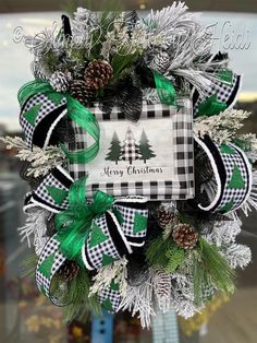 a christmas wreath with pine cones and evergreens