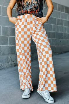 Our mid-rise Checkmate Pants are here to take trousers to another level. With a comfy elastic waistband and a wide-leg fit, they'll have you looking stylish and feeling cozy! Perfect for a casual day out, the washed black and white checkered print creates a bold and stylish look. Go ahead, make your move! Mid-rise waist Comfy elastic waistband Wide leg fit Camel and white checkered print 80% Polyester, 15% Rayon, 5% Spandex See Lily's sizing HERE, she is wearing size Small See Margie's sizing HE Teacher Fits, Wide Leg Lounge Pants, Checkered Pants, Casual Sweatpants, Wide Leg Sweatpants, Checkered Print, Loose Trousers, Clubwear For Women, Pants Vintage