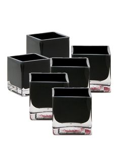 four black square vases sitting next to each other