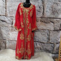 This Elegant 2 Pieces Red And Gold Embroidered Abaya Features Intricate Gold Ornate Embroidery Along The Neckline, Down The Front, And On The Edges Of The Sleeves And The Bottom Hem. The Set Includes One Dress And A Long Embroidered Kimono/Goddess Duster/Cover Up. Size: Large Bust:46" Hips:48" Length:58" Sleeves: 28" Long Sleeve Abaya With Zari Work, Traditional Red Long Sleeve Kaftan, Red Long Traditional Wear With Dabka Work, Red Long Thobe For Eid, Bollywood Style Embroidered Long Sleeve Abaya, Red Long Embroidered Dress, Red Long Sleeve Embroidered Dress For Festivals, Red Long Sleeve Embroidered Dress For Wedding, Traditional Red Maxi Length Kaftan