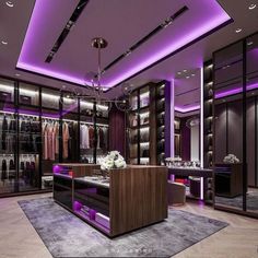 a large walk in closet with purple lighting