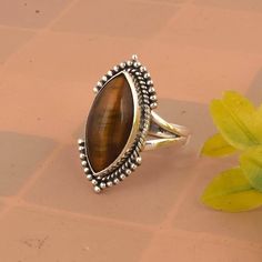 Tigers Eye Ring, Chunky Vintage Statement Ring, Natural Gemstone Ring, Womens Jewelry, Gift For Her * Material: High Quality Solid 925 Sterling Silver * Finish: Oxodised Silver Tiger Eye is a type of chatoyant gemstone that is prized for its unique, iridescent sheen. It's a type of quartz that has been subjected to high pressure and temperature, which causes the formation of fibers that create a shimmering, layered effect. Color: Tiger Eye typically has a golden, yellow-brown color with a metall Classic Sterling Silver Rings With Gemstone Accents, Brown Gemstone Rings For Anniversary, Sterling Silver Fine Jewelry Ring With Gemstone, Sterling Silver Marquise Gemstone Rings, Formal Sterling Silver Rings With Natural Stones, Luxury Marquise Sterling Silver Rings, Anniversary Rings With Natural Stones, Sterling Silver Crystal Ring With Polished Finish, Sterling Silver Crystal Ring Fine Jewelry