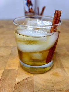 a glass filled with ice and cinnamon sticks