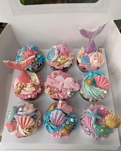 cupcakes in a box decorated with mermaid decorations