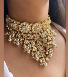 This Gorgeous Sabyasachi inspired Victorian Necklace with matching earrings. Comprises of Fine Oversized Uncut Kundan polki stones and white color hangings This choker is flexible and takes the shape of the neck. Fine quality and craftsmanship. Perfect for desi weddings. Necklace comes in drawstring cord therefore adjustable Earrings length: Approx 3 inches Luxury Bollywood Jewelry With Meenakari, Luxury Kundan Necklace With Stone Work For Reception, Luxury Chandbali Necklace For Wedding, Luxury Kundan Necklace With Zari Work, Luxury Fusion Style Kundan Necklace For Festivals, Cloths References, Sabyasachi Wedding, Lehenga Ideas, Necklace Closure