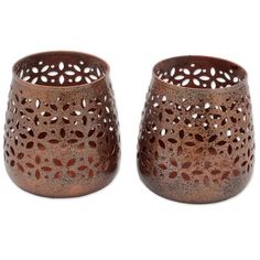 two brown vases sitting next to each other on a white surface with holes in the middle