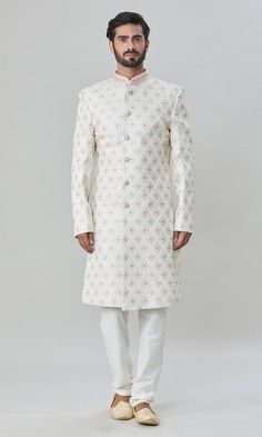 Off-white sherwani with floral and thread embroidery. Comes with pant. - Aza Fashions White Naqshi Sets For Festivals, White Naqshi Festival Sets, Festive White Churidar With Naqshi Detailing, White Naqshi Kurta For Festive Occasions, Festive White Set With Naqshi Details, Designer White Churidar With Naqshi Detailing, White Naqshi Churidar For Festivals, White Traditional Wear With Naqshi On Straight Kurta, Designer Traditional Wear With Dabka In White