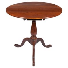 an old wooden table with two legs and a round top on the pedestal, against a white background