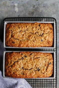 two loafs of oatmeal bread sitting on top of a cooling rack