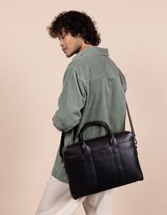 Everyone would agree: The Harvey is perfect company at work – a classic but contemporary work bag equipped to fit your laptop, newspaper, lunch, notebook and other work essentials. Harvey is styled with an easy access compartment in the front, short handles and a detachable crossbody strap. This version is a little smaller than the Harvey Maxi: the same function, just a little less bulk. This spacious bag is dressed with one zipper compartment for your 15″ laptop. Inside, one zipper pocket keeps your belongings safe and sound, and documents and such can go in the open space. The Harvey’s Black color is timeless yet totally on-trend. From dresses to jeans, it simply matches everything. OMB-E053CV Versatile Business Laptop Bag With Top Handle, Minimalist Workwear Briefcase, Versatile Satchel Laptop Bag For Business, Versatile Satchel Laptop Bag For Work, Leather Briefcase With Laptop Sleeve, Black Shoulder Bag With Luggage Sleeve For Office, Black Functional Satchel For Office, Classic Black Laptop Backpack, Classic Black Laptop Bag For Everyday Use