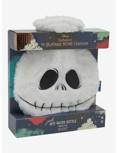 a white stuffed toy with black eyes in a box