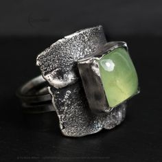 Modern, Brutalist-style Textured Ring. Fully handmade work.  Oxidized 925 Sterling Silver and 999 Fine Silver. The main accent of this ring is a natural green Prehnite. Material: 925 Sterling Silver,999 Fine Silver, Prehnite. The height of the central part is 2.4 cm. Size: 7.5 US, P UK. Color: Silver, Green. Green Oxidized Artisan Jewelry, Artisan Green Jewelry With Oxidized Finish, Green Artisan Jewelry With Oxidized Finish, Green Fusion Rings For Formal Occasions, Handmade Modern Green Jewelry, Modern Handmade Green Jewelry, Modern Green Handmade Jewelry, Green Handmade Modern Jewelry, Artisan Untreated Open Ring Jewelry