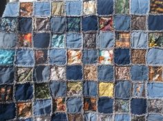 a quilt made with blue and multicolored squares