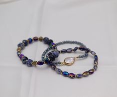 Introducing our Gold Blue Purple Glass Stone Bead Bracelet Set. Made with the highest quality glass stones, this bracelet set will add a touch of elegance to any outfit. Its unique combination of colors allows for versatile wear, making it a must-have accessory for any fashion-forward individual. Size: 6.5” - Inner Diameter Closure: Elastic Material: Zinc, Brass and Steel with Rhodium Plating Lead and Cadmium Safe - It is not Nickel Free Gold Bracelet Set, Holiday Jewelry, Purple Glass, Wedding Weekend, Instagram Shop, Ring Bracelet, Ring Necklace, Shop Necklaces, Bracelet Set