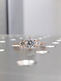 a diamond ring sitting on top of a table