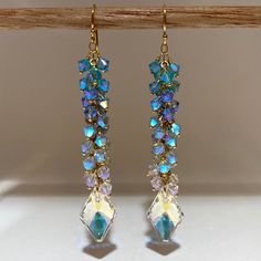 These eye catching, meticulously handcrafted earrings where made using authentic, ultra mint condition Swarovski Crystals, carefully wrapped with 14k Gold Filled ball pins Ombre Style attached to 14k gold filled chain and ear wire.  Composed with 4mm Light Turquoise Aurora Borealis 2X, Light Sapphire AB2X, Air Blue Opals AB2X, Clear Shimmery Crystals and gorgeous Swarovski Pendants to create a magical effect that is truly mesmerizing.  *They look SPECTACULAR during the day and are more than perfect for many occasions.  *They can be that something blue for your wedding.  * Upgrade any casual look with these gorgeous pair of earrings. I guarantee you will be complimented. Length: 3 inch drop Width: 10-12mm Message me if you want this style in a different length, if you need more quantities o Swarovski Pendant, Ombre Fashion, Light Sapphire, Earring Ideas, Light Turquoise, Handcrafted Earrings, Jewelry For Her, Blue Ombre, Blue Opal