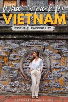 a woman standing in front of a wall with the words what to pack for vietnam essential packing list