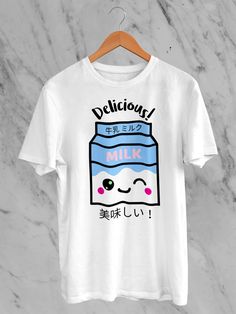 Welcome to our Etsy boutique, where style meets adorable sophistication! Explore our Japanese Kawaii Delicious Milk T-Shirt -- a delightful fusion of Japanese cuteness and contemporary flair. This tee boasts a Delicious Milk illustration featuring irresistibly charming strawberries and the essence of kawaii culture. Crafted from premium materials, this shirt ensures comfort without compromising on style. The Japanese-inspired design adds a touch of playful elegance to your wardrobe, making it a must-have for those who appreciate the art of kawaii fashion. Each shirt is a canvas of sweetness, blending the iconic strawberry motif with the popular Japanese aesthetic. Our Kawaii Delicious Milk T-Shirt is not just a garment; it's a statement. Perfect for casual outings or expressing your unique White Harajuku Top With Funny Print, Kawaii Cotton T-shirt With Letter Print, Kawaii Cotton T-shirt With Crew Neck, White Harajuku T-shirt With Cartoon Print, Cute Cartoon Print Crew Neck T-shirt, Kawaii T-shirt With Cartoon Print Crew Neck, Kawaii Cotton T-shirt With Cartoon Print, Kawaii Cotton Crew Neck T-shirt, Cute Crew Neck T-shirt With Cartoon Print