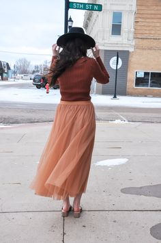 The Elastic Waist Maxi Tulle Skirt is a stunning and versatile addition to your wardrobe. This maxi skirt combines elegance with comfort, making it perfect for a wide range of occasions. Featuring an elastic waist, it offers a customizable and comfortable fit. The skirt is finished with a raw hem, which adds a contemporary touch to its overall design. It is fully lined, both in the body and skirt, providing comfort and coverage. Crafted from 100% polyester for both the self and lining, this skirt offers a luxurious and flowing feel, ensuring you move with grace and style. The model, standing at 5' 9" and with measurements of 31-24-34, is wearing a size Small. Whether you're dressing up for a special event or looking to make a statement with your everyday attire, the Elastic Waist Maxi Tull Elegant Non-stretch Tulle Skirt, Chic Non-stretch Tulle Skirt, Tiered Maxi Skirt For Fall Party, Fitted Tulle Skirt For Winter, Winter Fitted Tulle Skirt, Fitted Maxi Skirt For Fall, Fall Fitted Maxi Skirt, Chic Stretch Full Maxi Skirt, Winter Flared Tulle Skirt