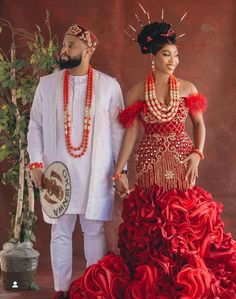 a man and woman dressed in traditional african clothing