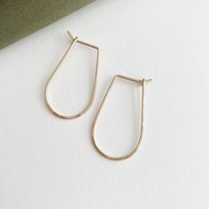 These 14k gold hoops are perfect for everyday wear. Named after the Greek goddess of wisdom and strength, these earrings will elevate your look each time you reach for them. Each purchase comes with an elegant, vegan leather box for storing + caring for your jewelry. DETAILS14k Solid Gold | 1 1/8" in length, 5/8" wide Everyday Hammered Huggie Jewelry, Minimalist 14k Gold Teardrop Huggie Earrings, Everyday 14k Gold Teardrop Huggie Earrings, Yellow Gold Teardrop Hoop Earrings For Everyday, Everyday Yellow Gold Teardrop Hoop Earrings, 14k Gold Filled Yellow Gold Threader Earrings For Everyday, Gold Sterling Silver Hoop Earrings For Everyday Elegance, Everyday Yellow Gold Teardrop Threader Earrings, Gold-toned Sterling Silver Hoop Earrings For Everyday Elegance