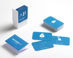 four blue business cards sitting next to each other on a white surface, with the logo and brand name printed on them