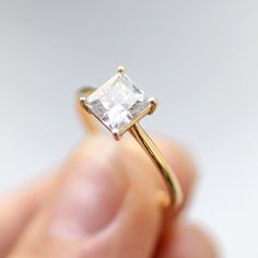 ✦ Main Stone Details✧ Shape: Princess Cut Moissanite✧ Weight: 1.50CT (App. 6.5 mm)✧ Color: DEF(Colorless)✧ Clarity: VVS ✦ Ring Details✧ Band Width: 1.5 mm (± 0.10) [Customized Possible]✧ Metal: Gold (10KT, 14KT, 18KT)✧ Metal Tone: Yellow, White, Rose Radiant Cut Rings, Princess Diamond Ring, Princess Cut Moissanite, Moissanite Engagement Ring Solitaire, Types Of Diamonds, Bridal Ring Sets, Bridal Bands, Princess Diamond, Three Stone Rings