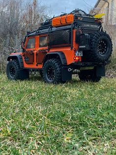 an orange and black truck parked in the grass