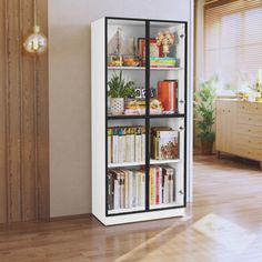 a book case with many books inside of it on the floor next to a window