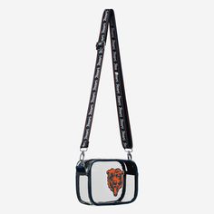 Over your shoulder and off to the game. Whether you're running errands on the town or running the tailgate in the parking lot, this Chicago Bears Team Stripe Crossbody Bag is the perfect way to carry the team like never before. Features Team-colored border so you can rep the team in style Bold team logo display, in case there were any doubts where your allegiances lie Woven, team-colored crossbody strap that makes carrying the team easy and convenient Repeat script team name display on strap for Logo Display, Parking Lot, Chicago Bears, Team Names, Bold Fashion, Team Spirit, Team Colors, Crossbody Strap, Running Errands